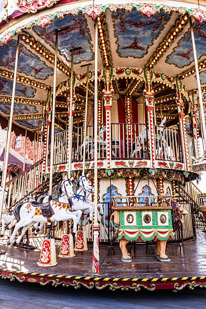 istock Vertical front view of a beautiful carousel with white horses for holiday entertaining. children's fun attraction on holidays in squares of Moscow. 2242541279