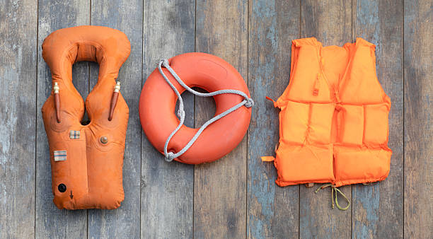 istock orange life jacket on wooden background 2242542104
