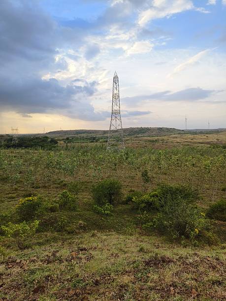 istock Electric tower in grassy area 2242543429