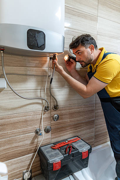istock Plumber fixing water heater with flashlight in modern bathroom during daytime 2242546605