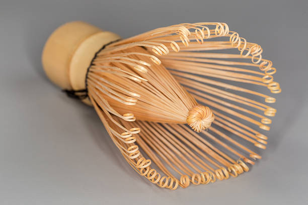 istock Bamboo whisk for preparing green matcha tea on gray background 2242547713