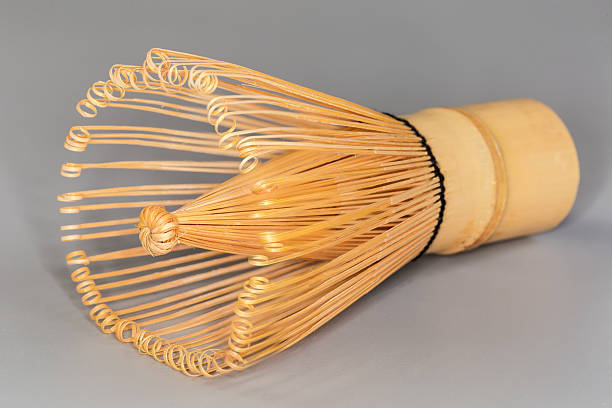 istock Bamboo whisk for preparing green matcha tea on gray background 2242548344