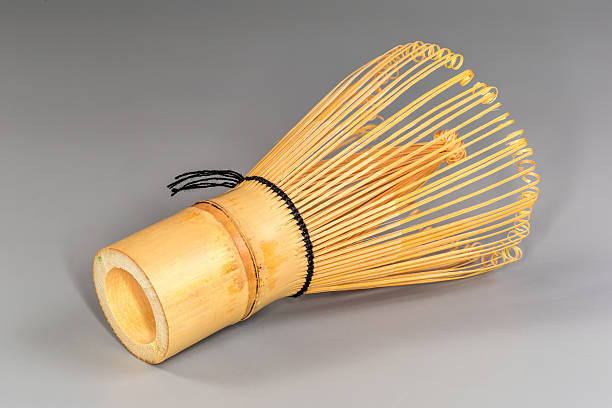 istock Bamboo whisk for preparing green matcha tea on gray background 2242548856
