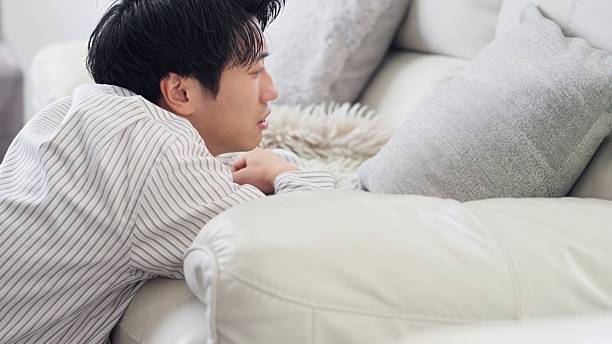 istock Depressed Asian man on the sofa 2242550935