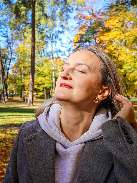 istock middle-aged woman sitting on bench 2242551655