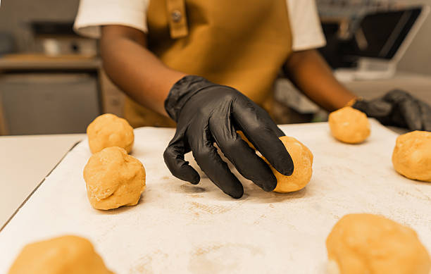 istock Woman baking cookies placing dough balls on tray 2242553729