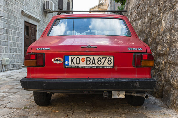 Perast, Montenegro - August 11, 2025: Zastava Skala 55. A red vintage car rear view featuring a European license plate