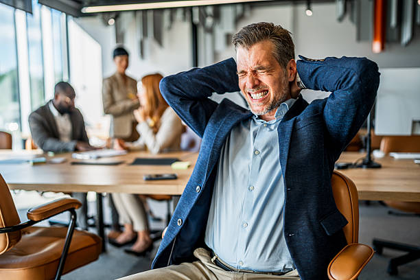 istock Businessman feeling neck pain suffering from stress 2242559595