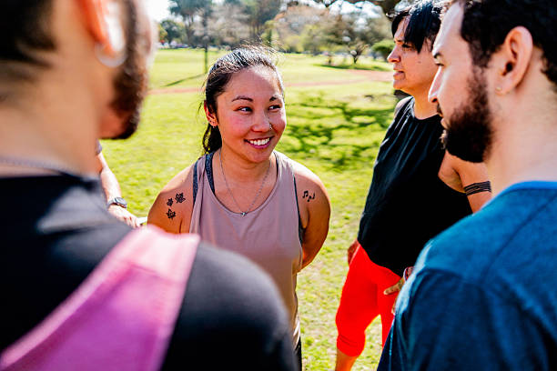 Athlete friends talking at public park