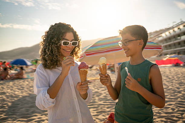 istock Siblings eating ice cream on the beach 2242560553