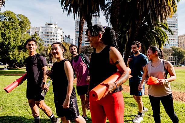Athlete friends talking and walking on public park