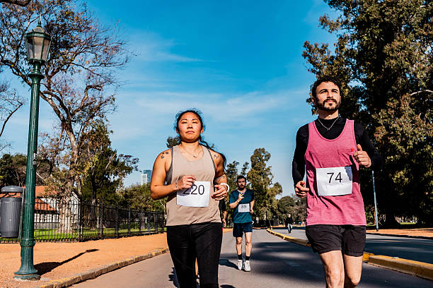 People running during marathon on public park