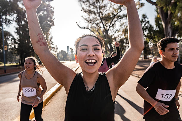 Young athlete woman running and celebration on marathon