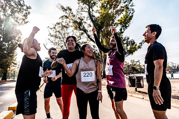 istock Friends celebrating after marathon on public park 2242560928
