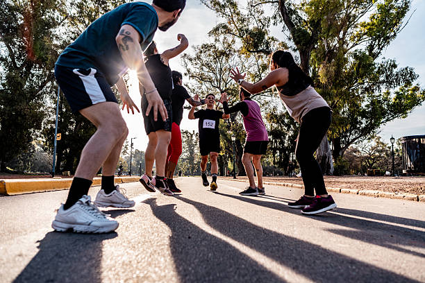 istock Friends celebrating after marathon on public park 2242560948
