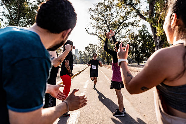 istock Friends celebrating after marathon on public park 2242561457
