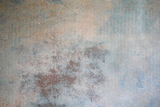 istock Abstract texture of a shabby old wall with peeling paint, cracks and chips 2242561860