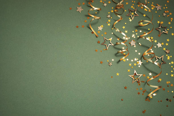 istock New Year, Christmas or birthday festive background top view. Celebration composition with golden confetti stars and serpentine party streamers. 2242561923