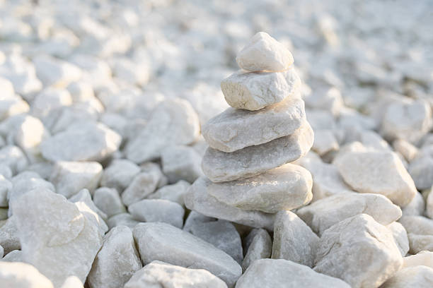 Stack of white decorative stones. Aesthetic tower for balance and zen meditation theme.