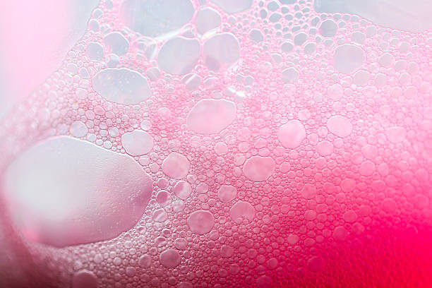 istock Pink foam macro background.Soft pastel pink soap bubble pattern.Cosmetics texture macro.Pink soap bubbles gently cascade downward. 2242564322