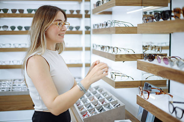 istock Woman selecting eyeglasses in optical store 2242567252