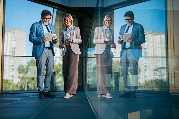 istock Senior business colleagues having coffee break with tablet 2242567502
