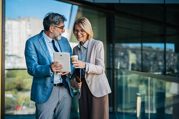 istock Business professionals discussing work on a coffee break outdoors 2242567593