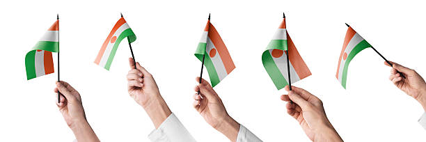 The Niger flag in hand in different angles on a white background.