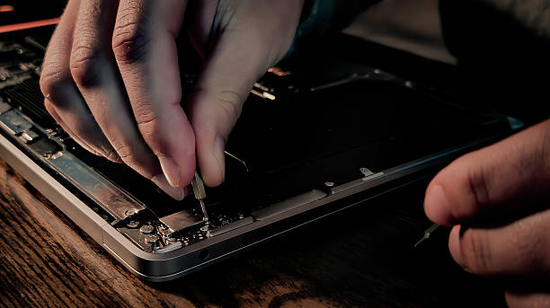 istock Home computer repair with dusty laptop and precision tools 2242570111