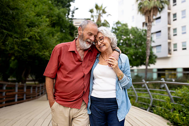 istock Senior couple sharing a tender moment walking in park 2242570508