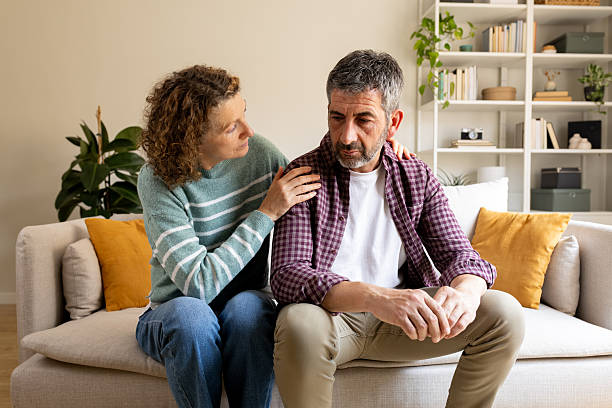 istock Mature woman comforting worried man during difficult times 2242570626