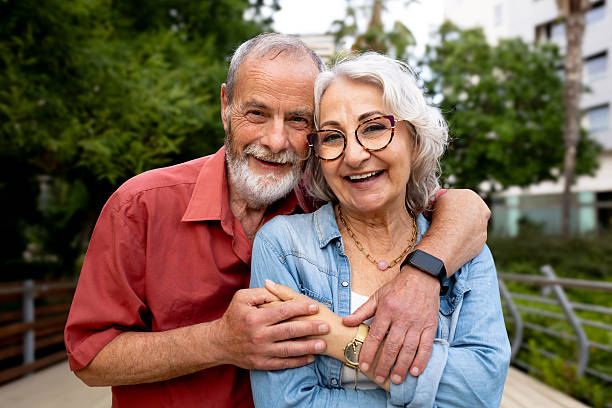 istock Senior couple embracing outdoors, feeling happy and in love 2242570643