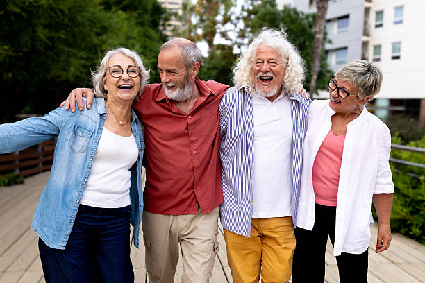 istock Senior friends laughing embracing outdoors enjoying time together 2242570646