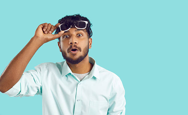 istock Funny surprised Indian guy looking at you with shocked expression on light blue background. 2242570796