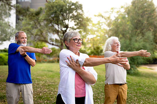 istock Senior adults stretching arms together in park 2242570947