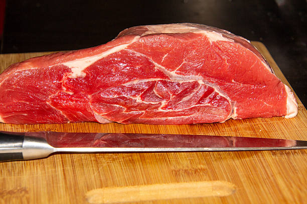 Lean rump steak, marinated in olive oil, Celtic salt, rosemary and pepper, being fried on a griddle.