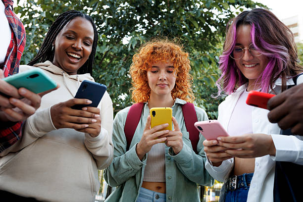 istock Group of students using smartphones outdoors 2242571916