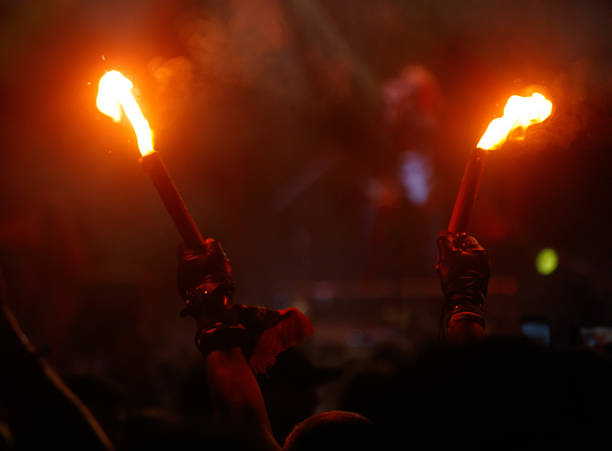 Fijian man holds a torch during a fire dance at nigh in Fiji. Real people copy space