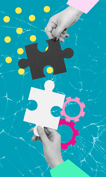 Hands connecting puzzle pieces against a bright background, symbolizing collaboration and problem-solving in a creative setting