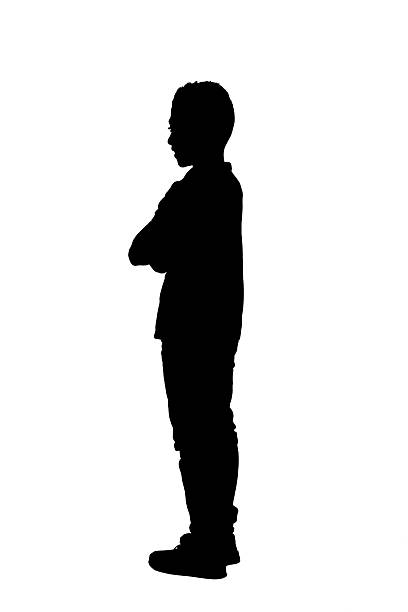istock silhouette of side view of a boy standing arms crossed on white background 2242573939