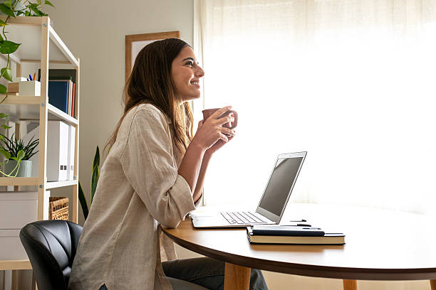 istock Young businesswoman drinking coffee while looking out the window during a work break 2242574284