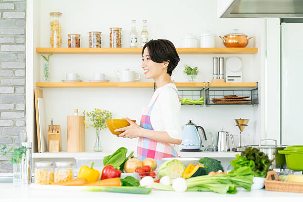 istock Middle-aged housewife standing in the kitchen 2242574612