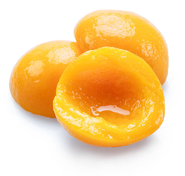 istock Peeled canned peach halves isolated on white background. File contains clipping paths. 2242576049