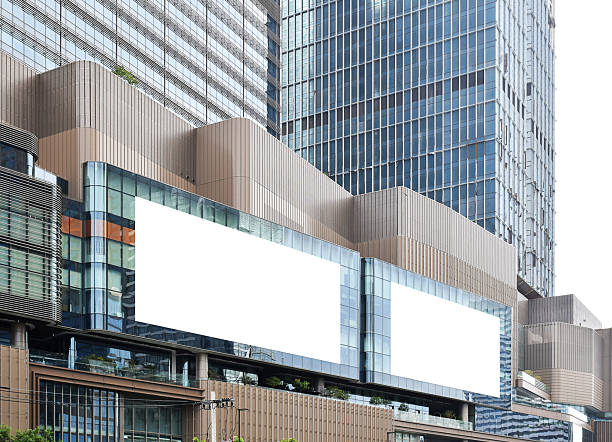 istock Two white mock up horizontal large LED display billboard on tower building. Clipping path for mockup 2242578672