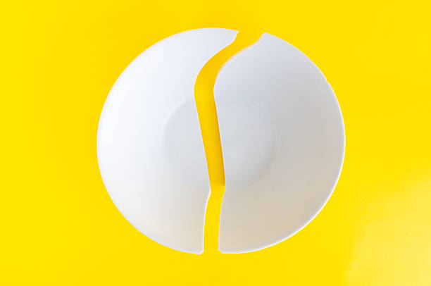 istock Broken plate close up on a yellow background 2242579288