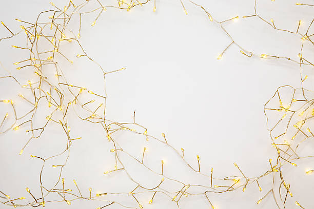 istock Soft glowing fairy lights on white background. Romantic minimal backdrop with copy space. 2242582389