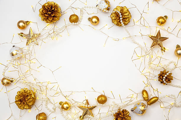 istock Christmas lights and gold baubles on white background. Copy space for festive greeting or design. 2242582400