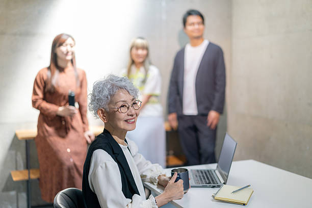 People having meeting with a senior woman