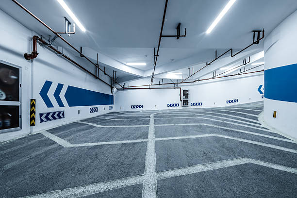 istock Curved entrance and exit ramp of a modern underground parking garage. 2242584817