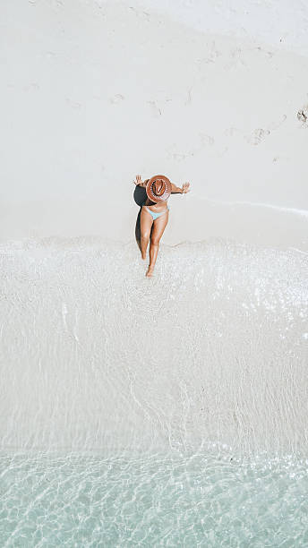 istock Woman Relaxing on White Sandy Beach Shoreline 2242586557